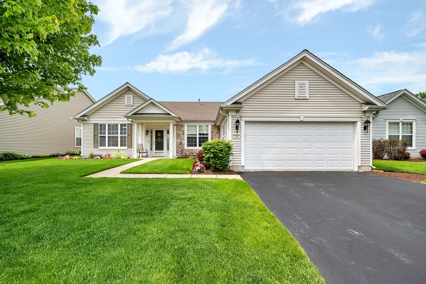 a front view of a house with a yard and garage