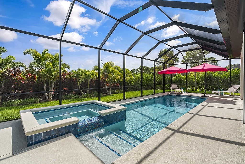 a view of swimming pool with a bench in patio