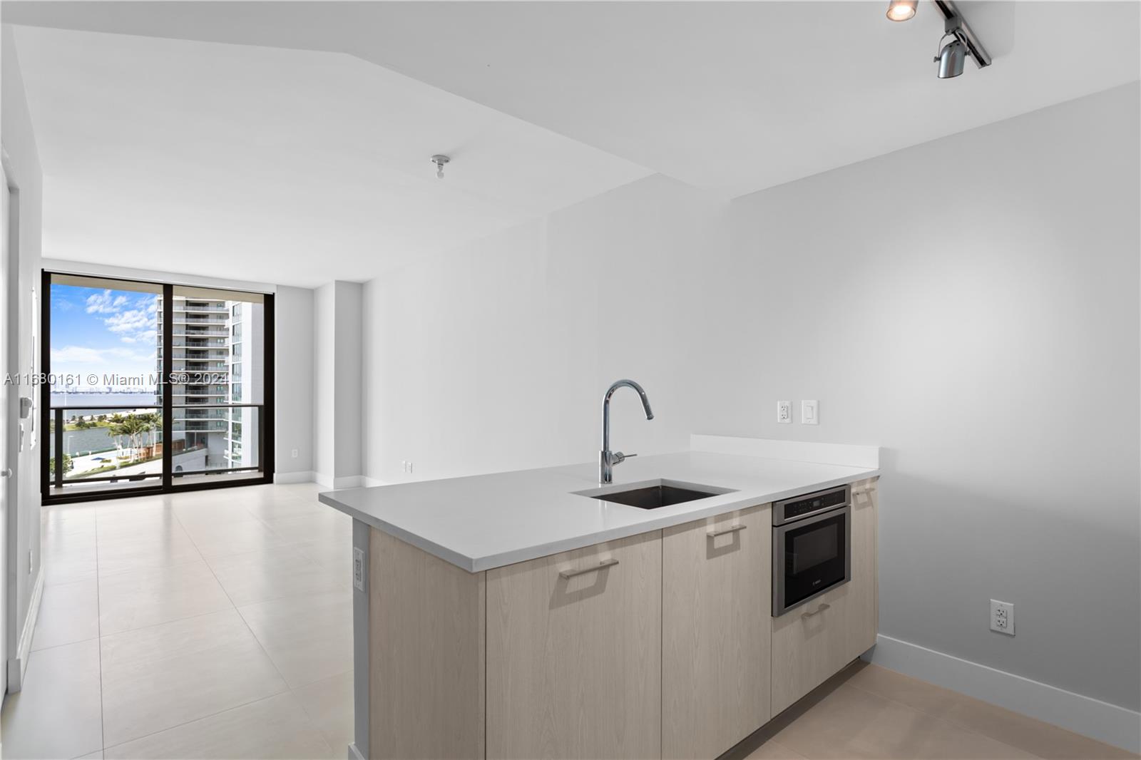 a view of a kitchen with stove and sink