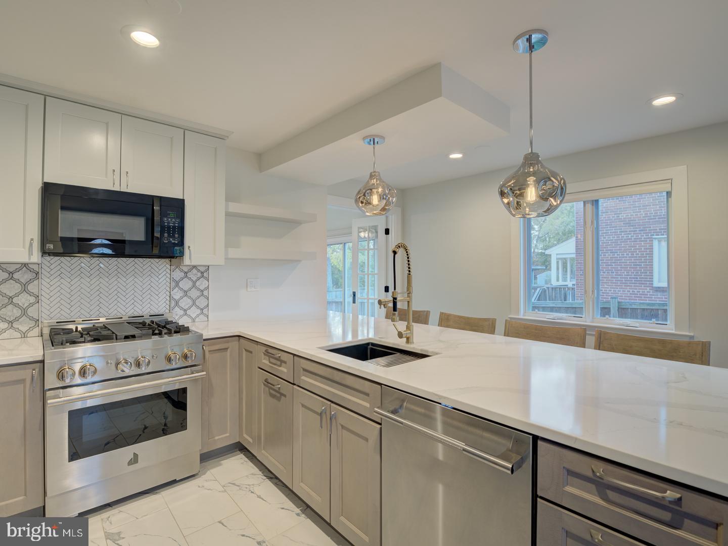 a kitchen with a sink stove and microwave