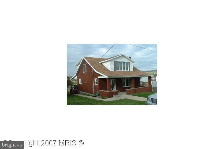 a picture of a bench in front of a house