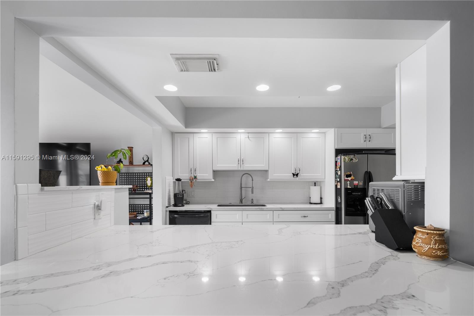a large white kitchen with lots of counter space