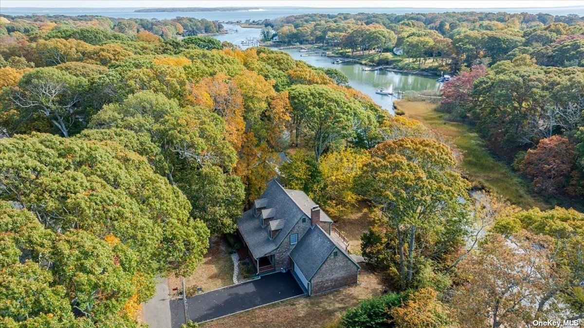 an aerial view of house with yard and mountain view in back