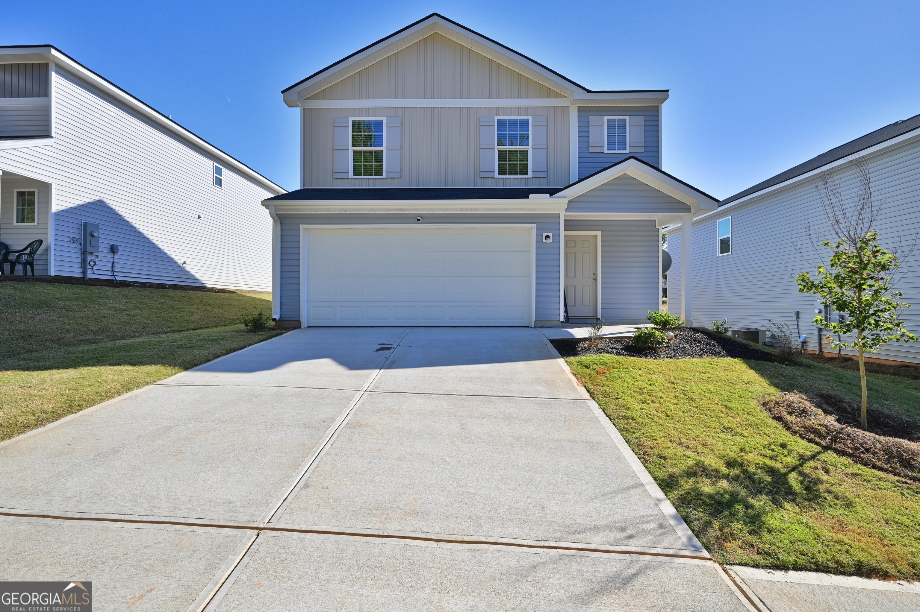 a front view of a house with a yard and garage