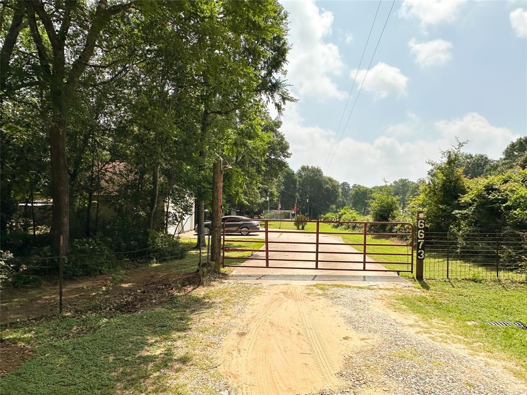 a view of a yard with wooden fence