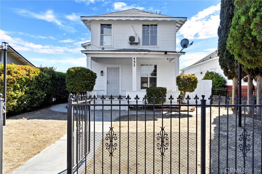 a front view of a house with wooden fence