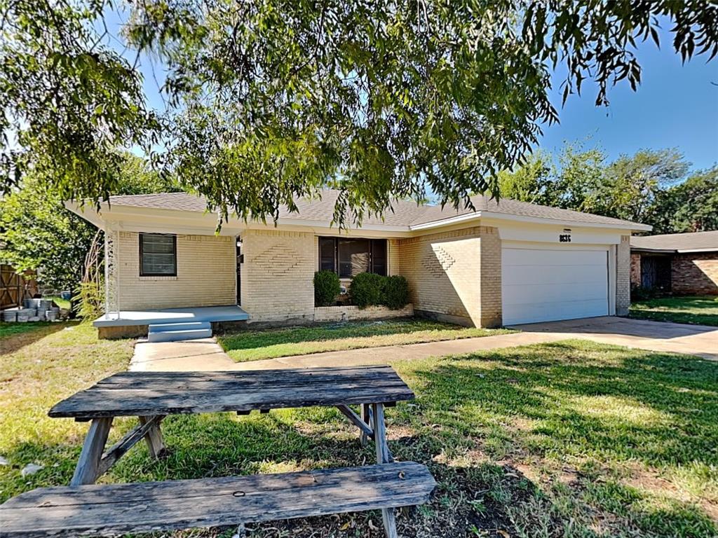 a backyard of a house with table and chairs