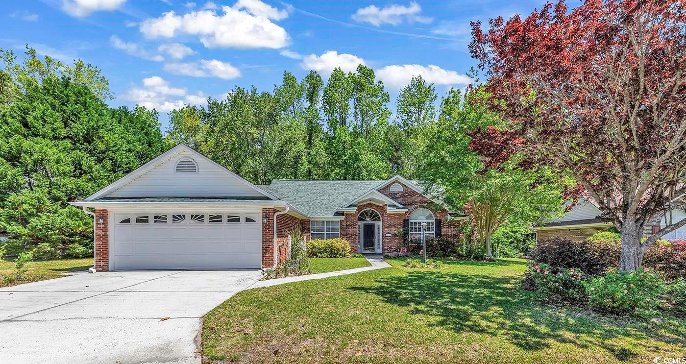 Single story home featuring a garage and a front l