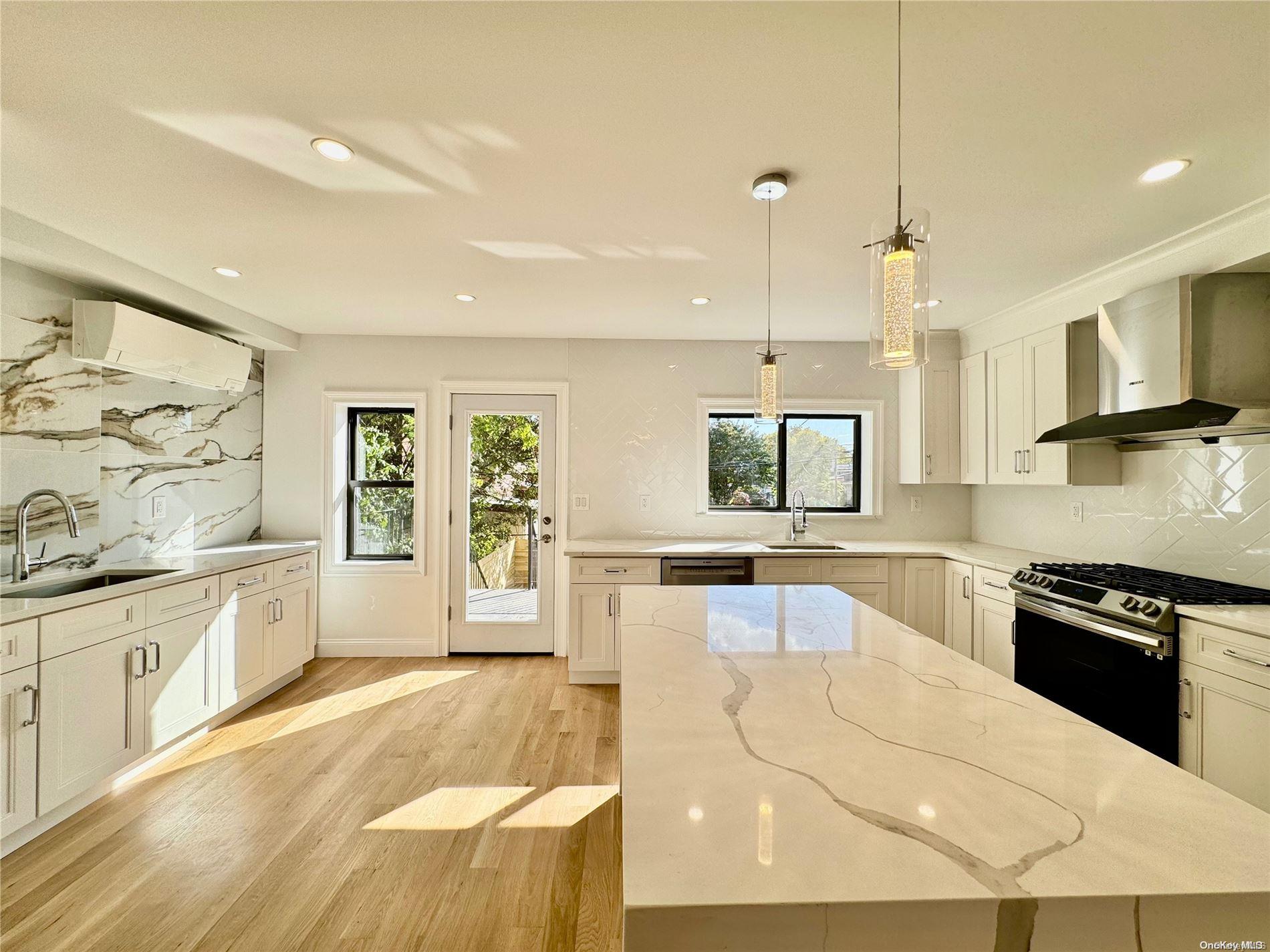 a kitchen with granite countertop a stove and a sink