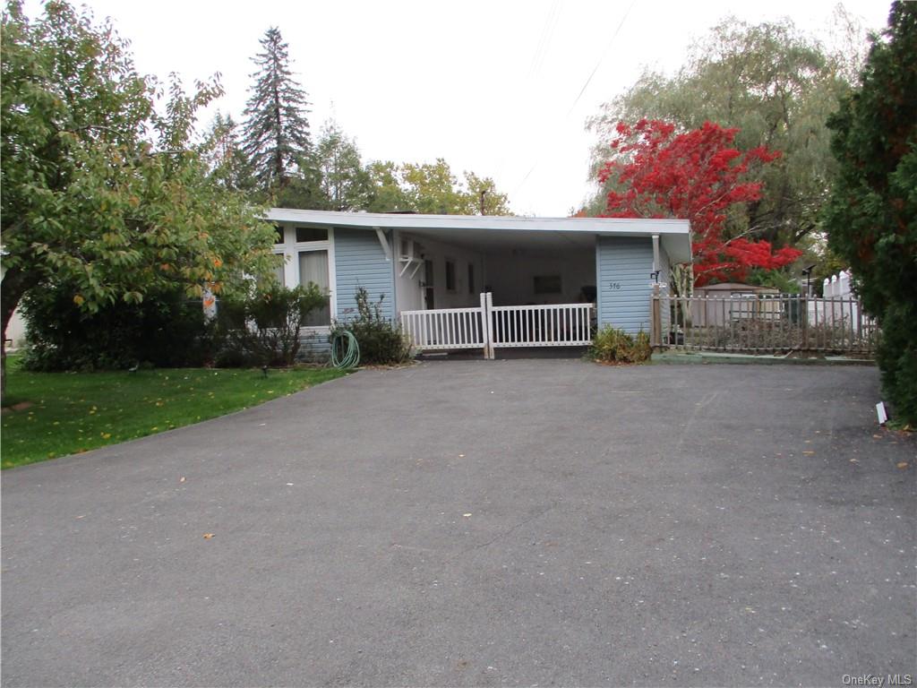 a view of a house with a yard and garage