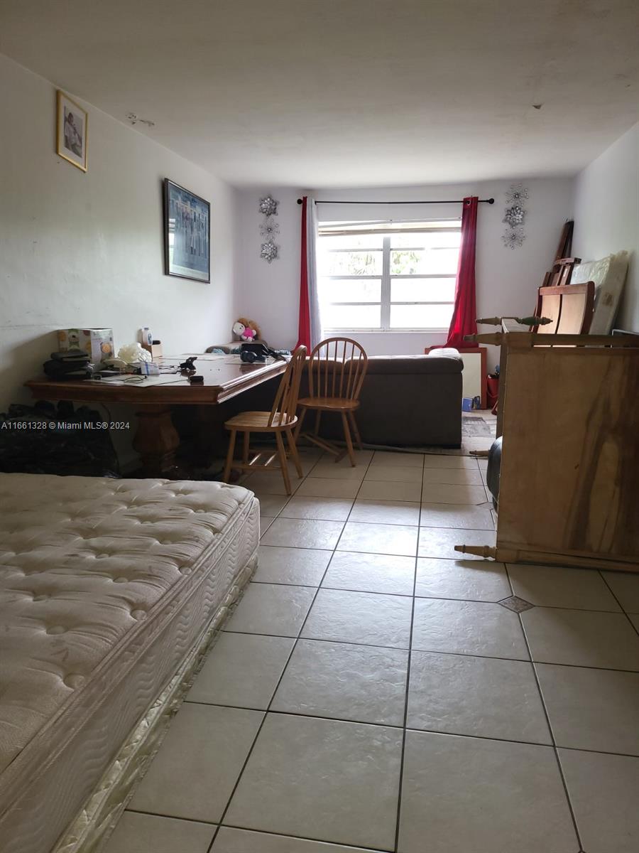 a living room with a couch and a dresser next to a window