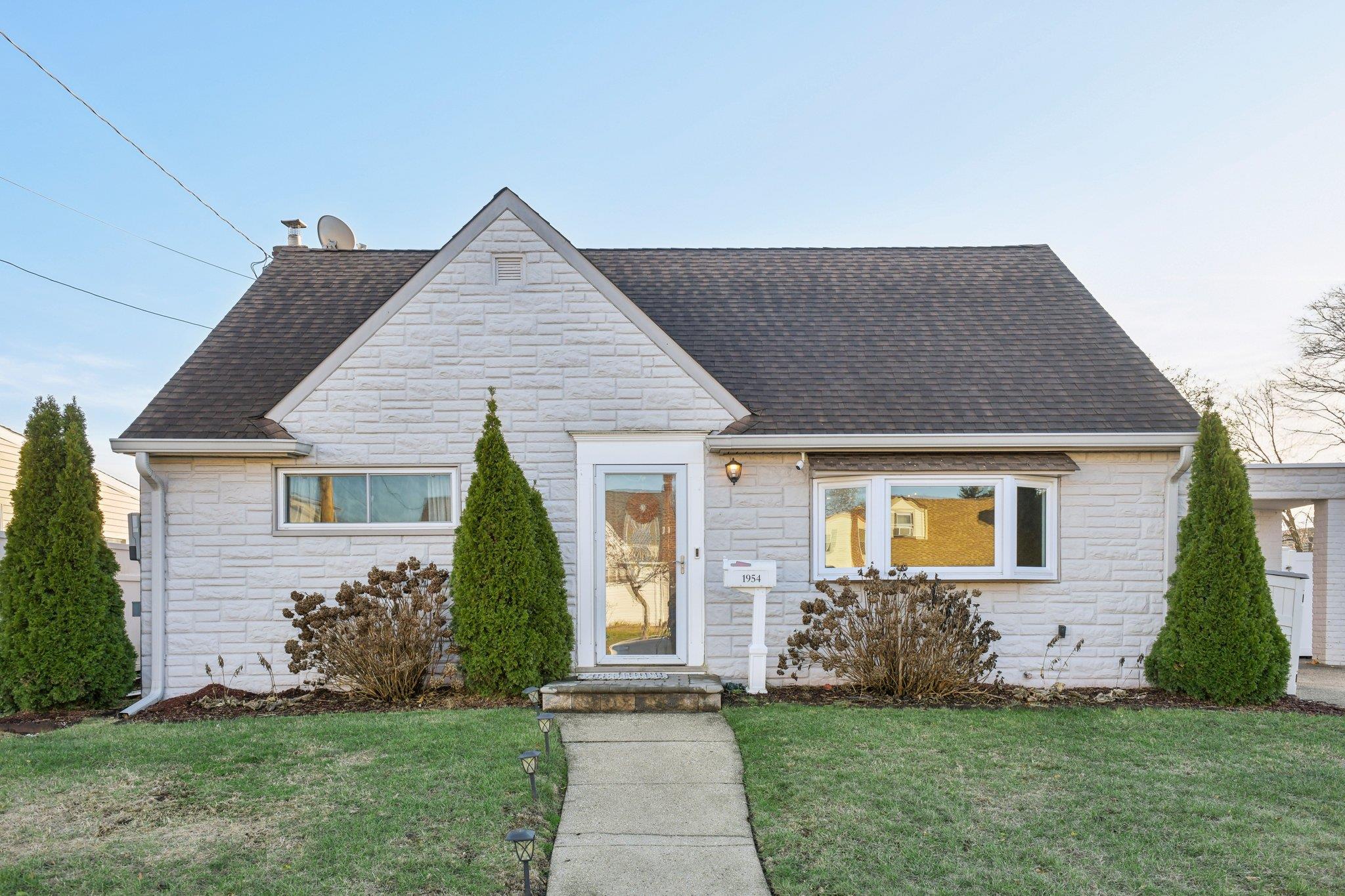 Bungalow-style house with a front yard