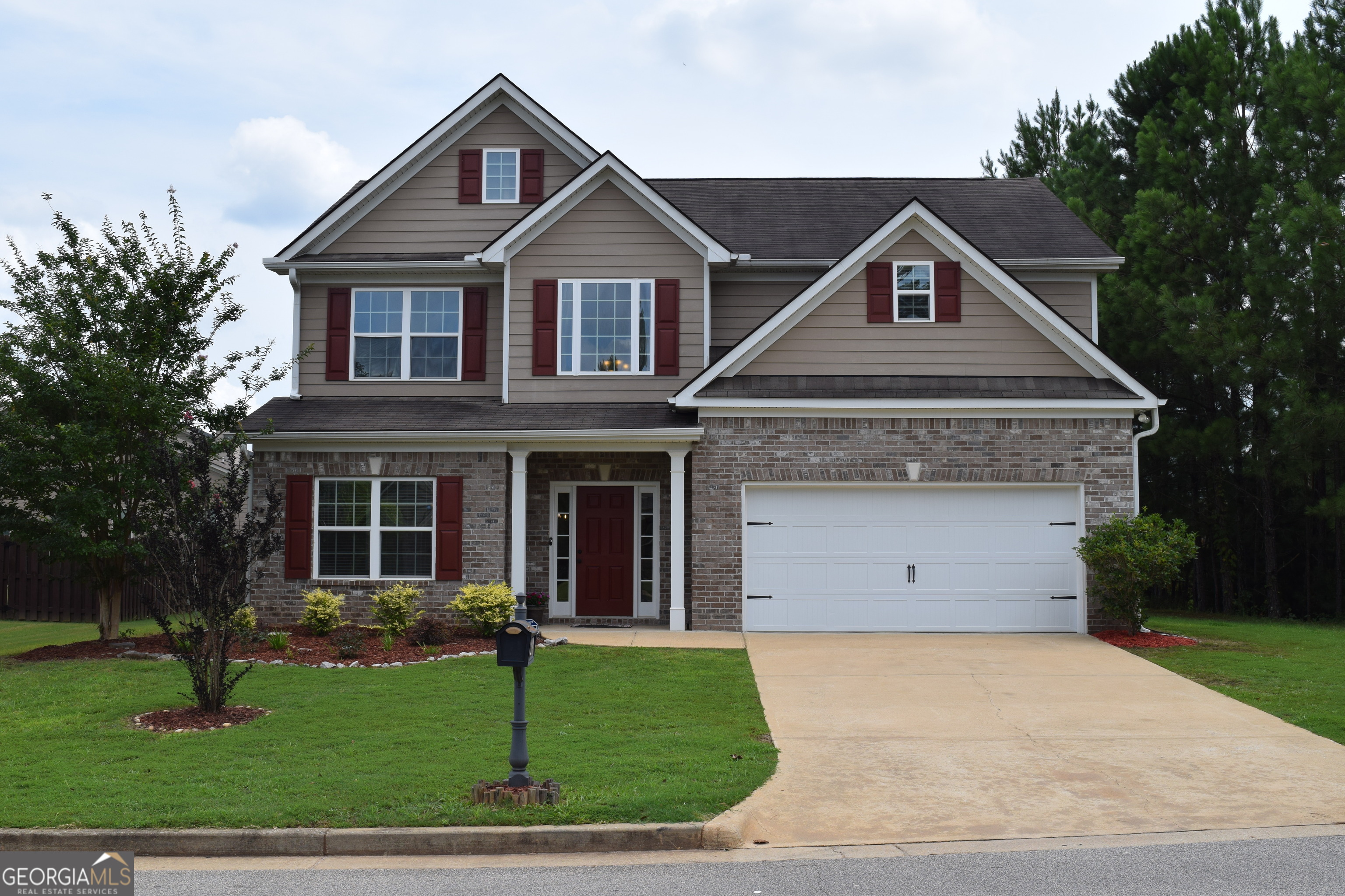 a front view of a house with a yard