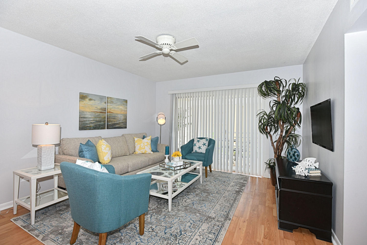 a living room with furniture a chandelier and a window