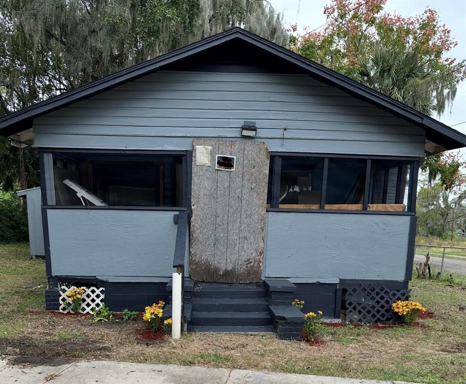 a front view of a house with plants