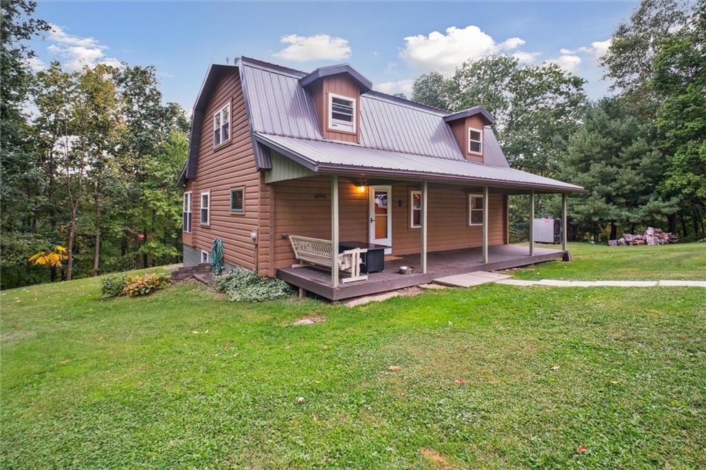 a view of a house with a yard porch and sitting area