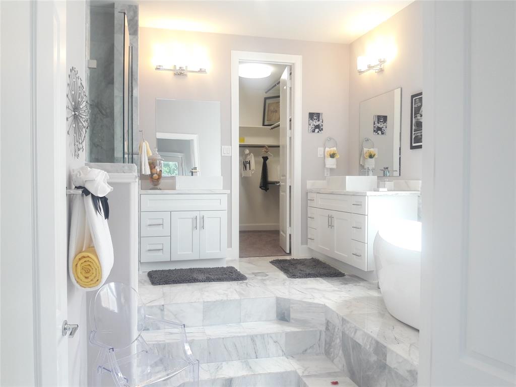 a bathroom with a tub sink and mirror