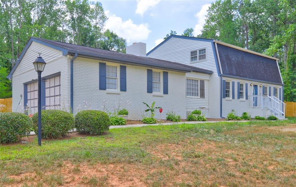 a view of front of house with a yard