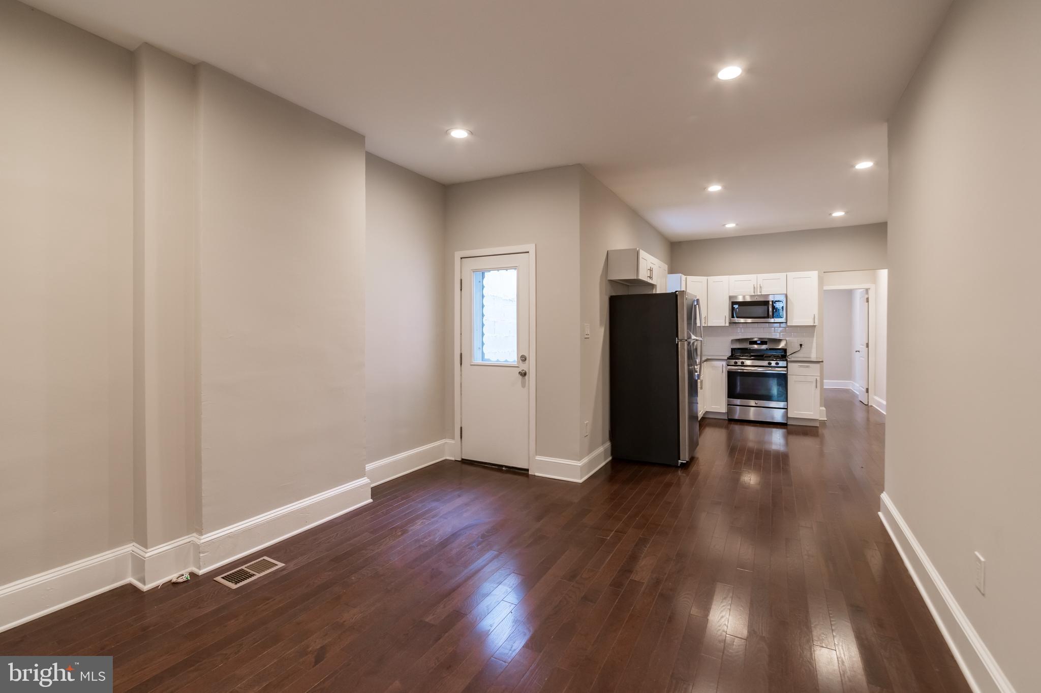 an empty room with wooden floor and closet