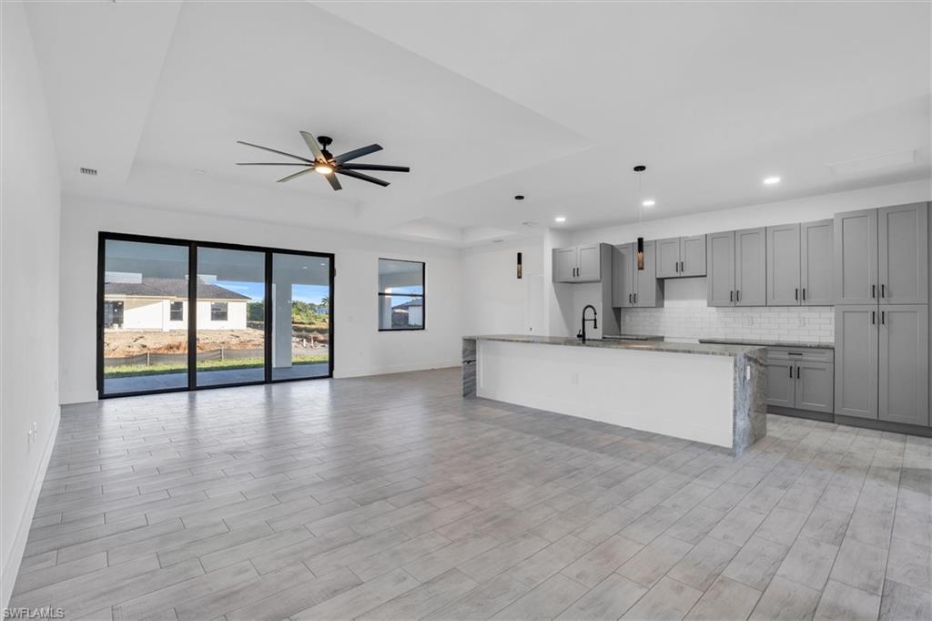 a view of large kitchen with a sink and a window