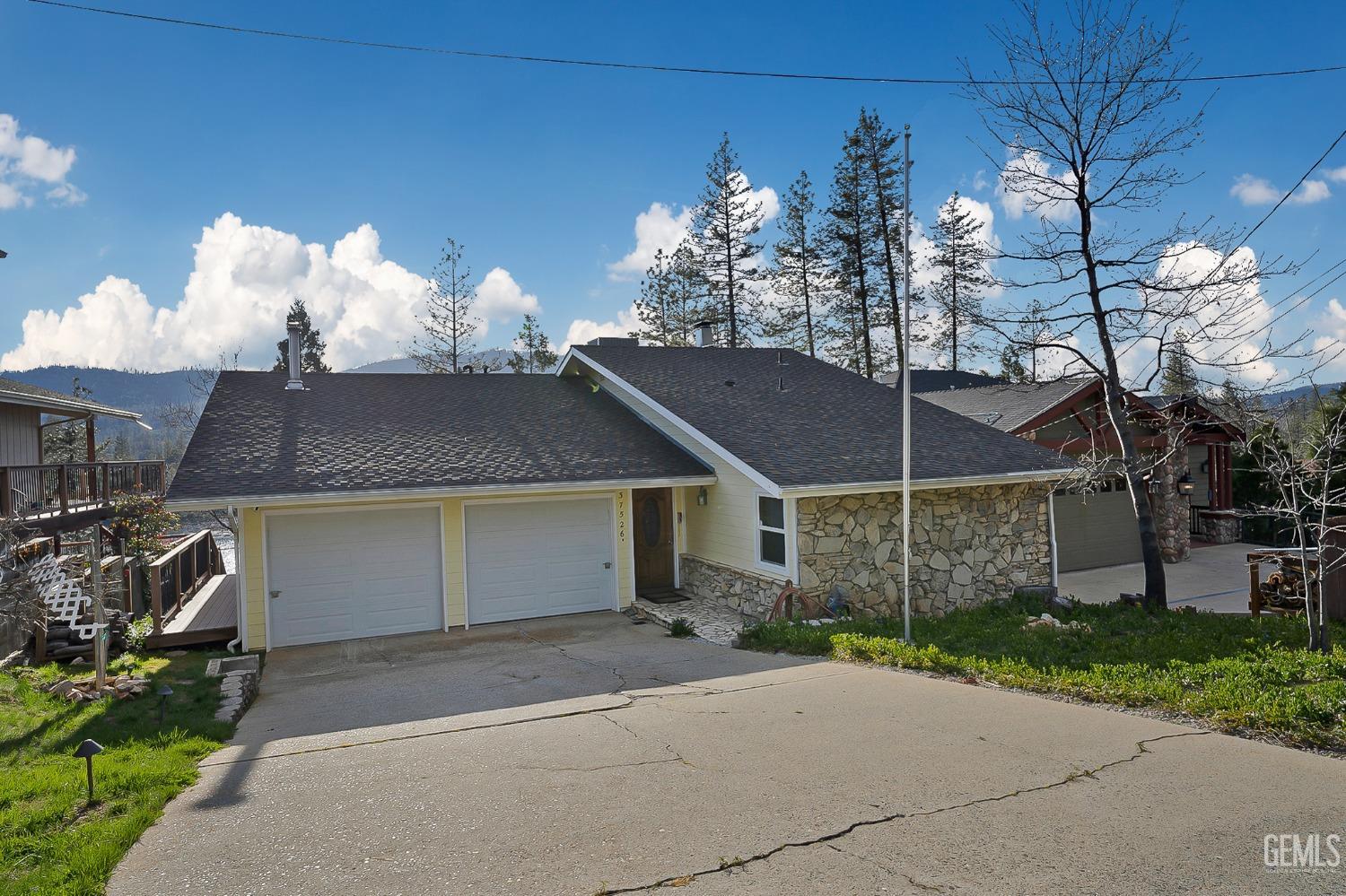 a front view of a house with a yard and a garage