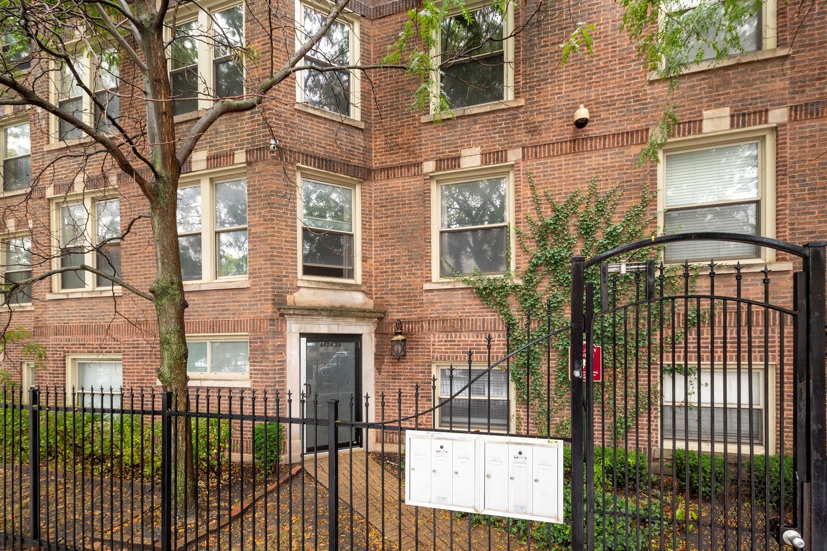 a view of a brick building next to a yard