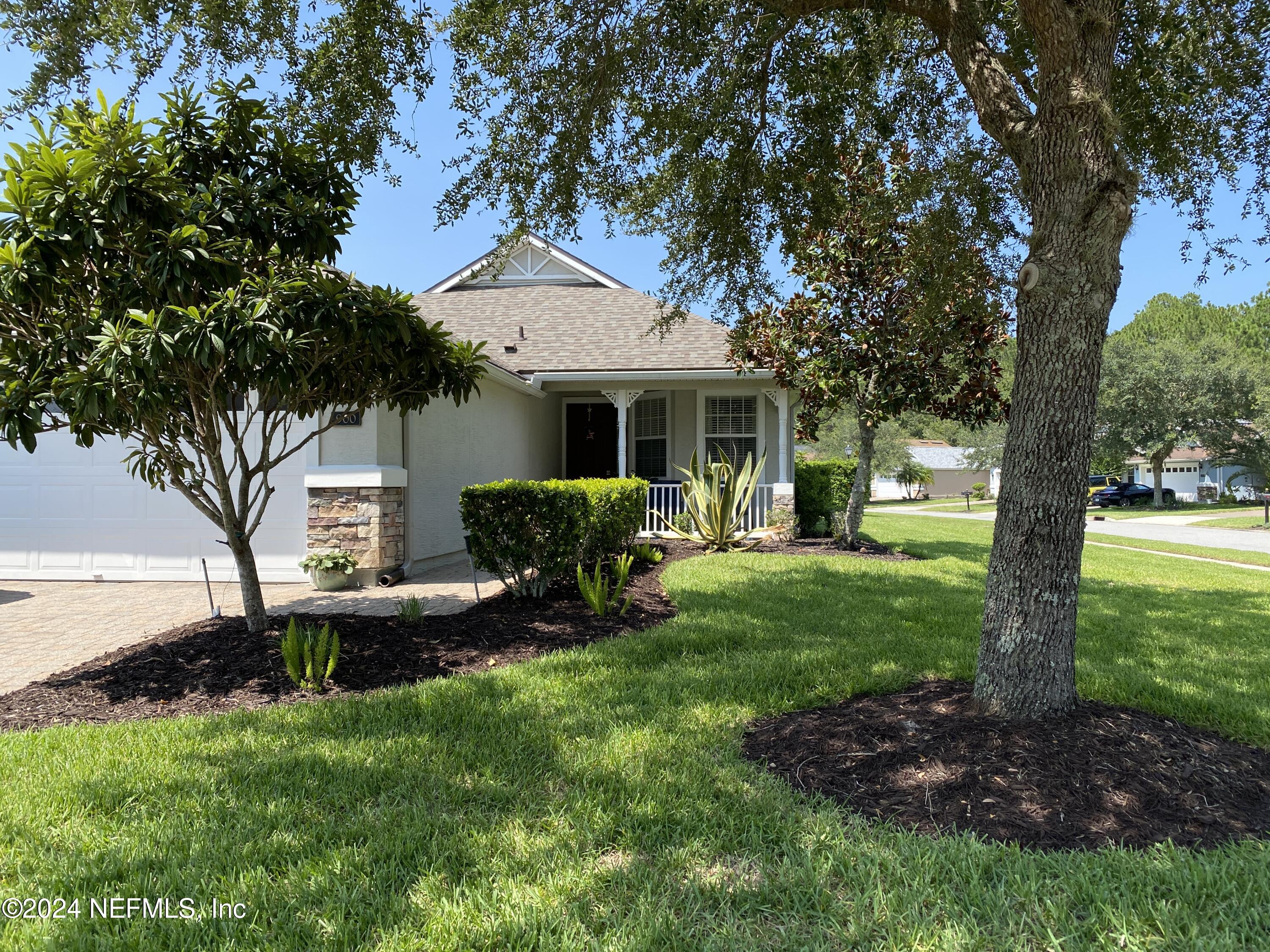 a view of a house with backyard sitting area and garden