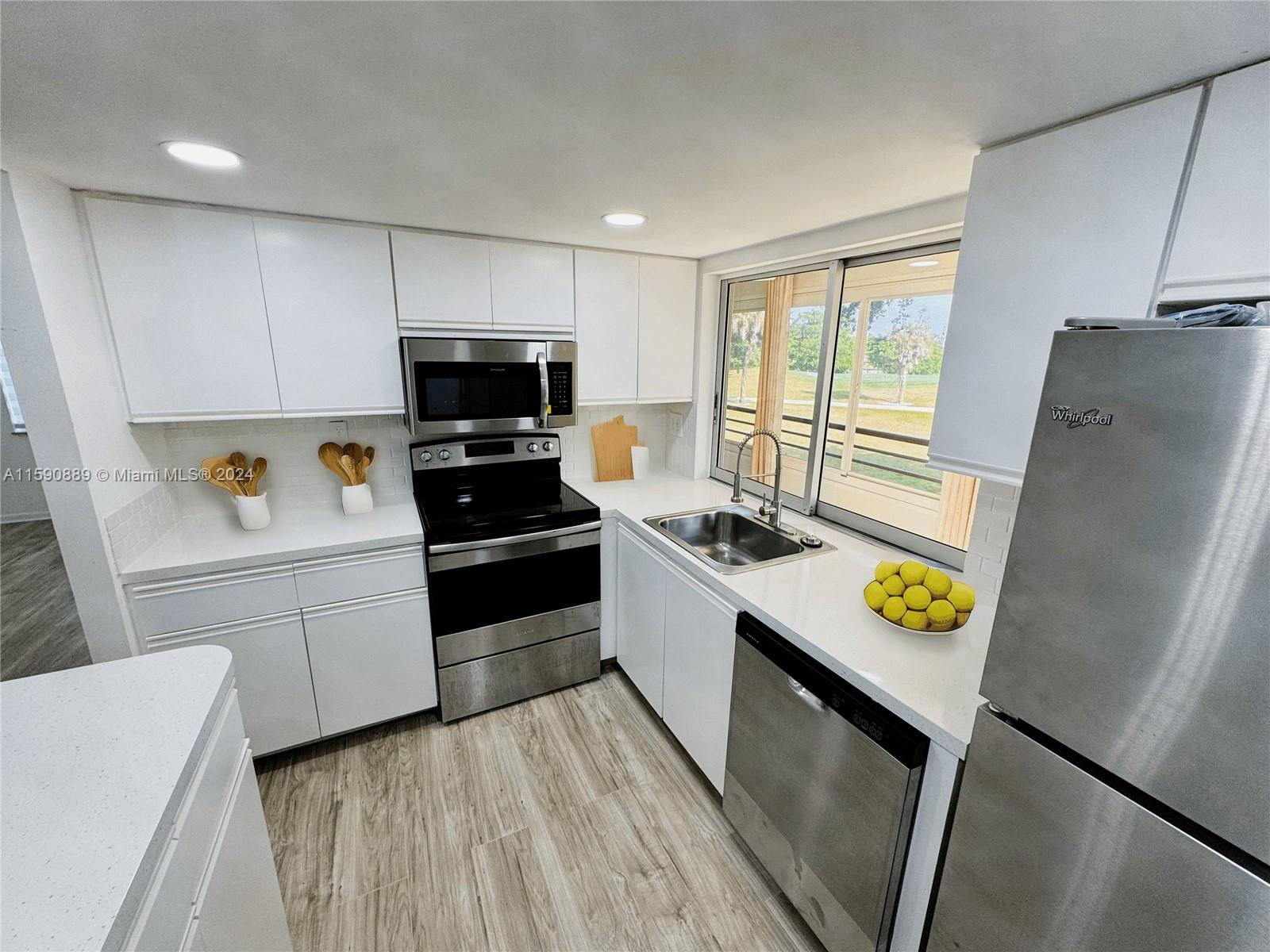 a kitchen with a stove a refrigerator and a sink