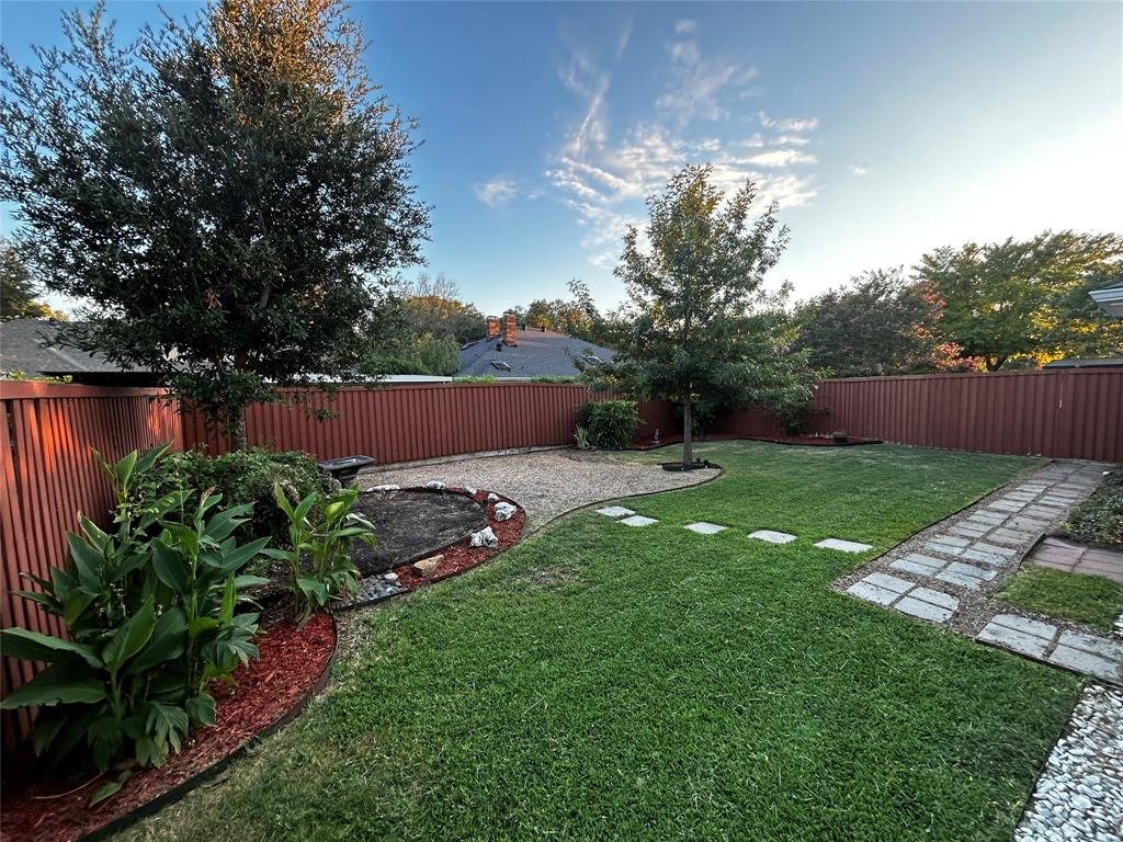 a view of yard with swimming pool and green space