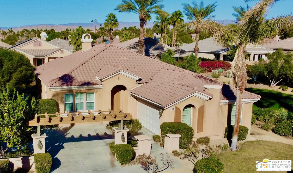 a aerial view of a house with a big yard and potted plants