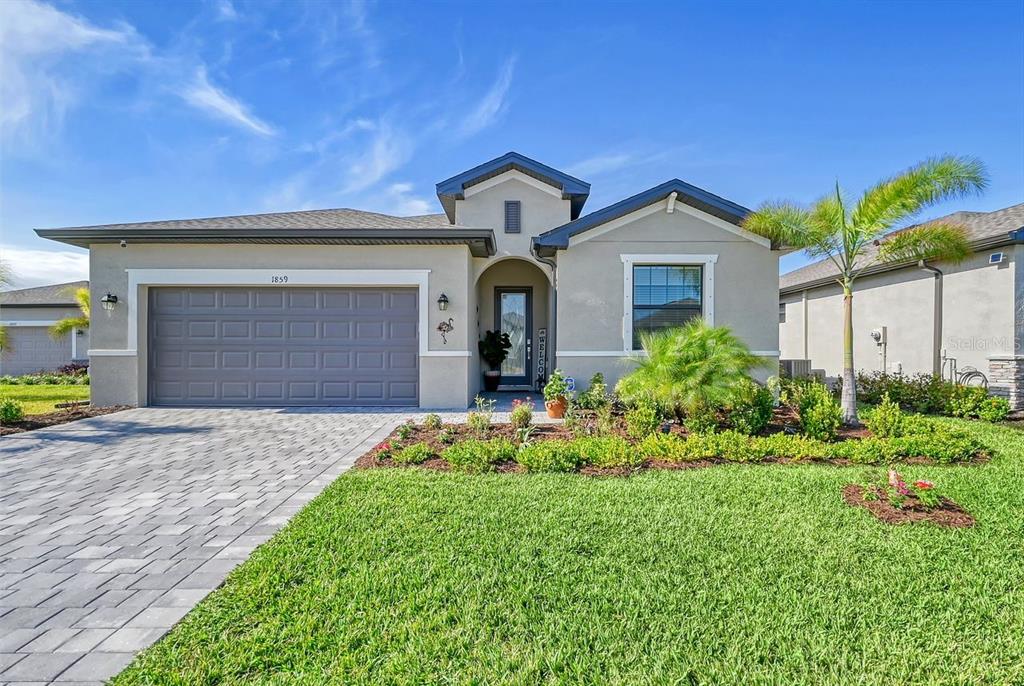 a front view of a house with a yard and garage