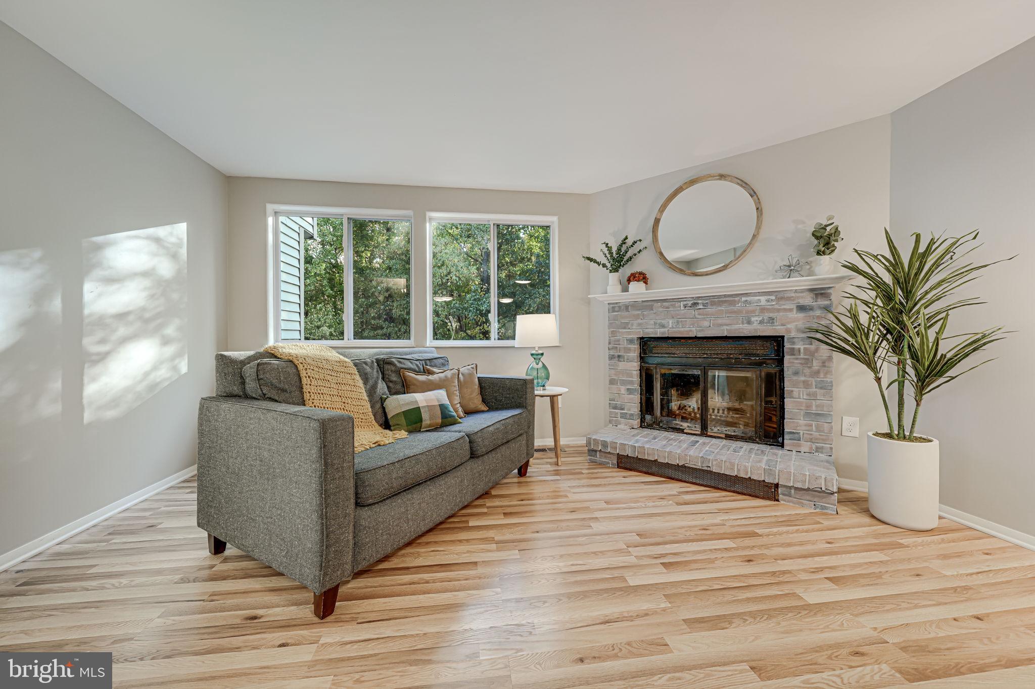 a living room with furniture a window and a fireplace