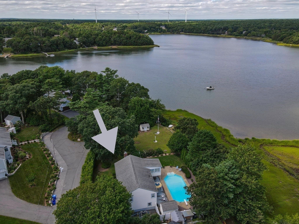 an aerial view of a house with a yard and lake view