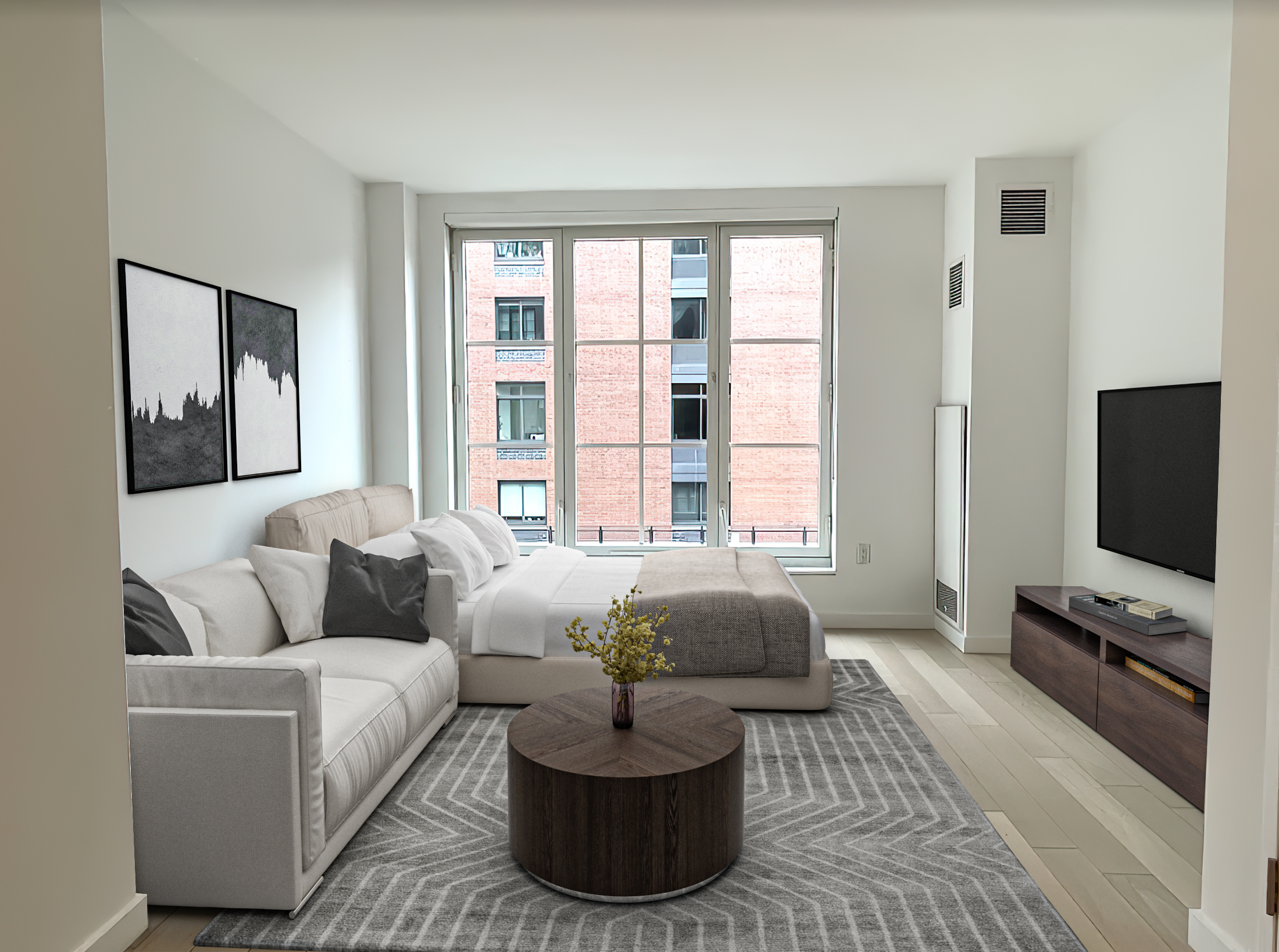 a living room with couches and a flat screen tv with kitchen view