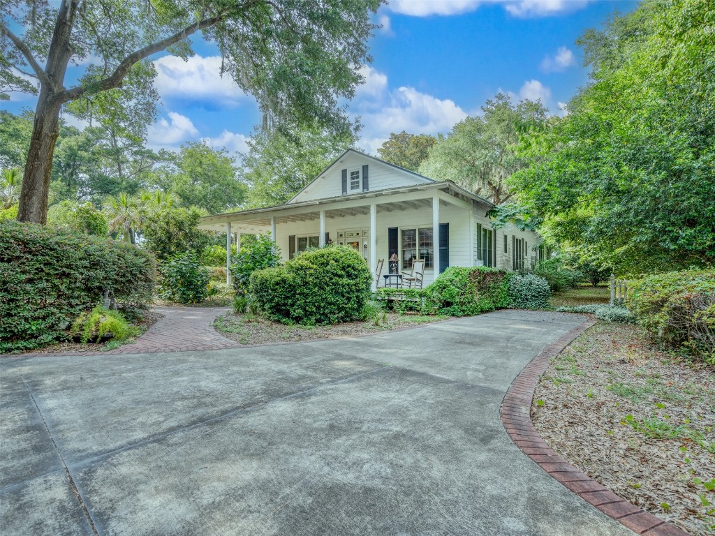 a front view of a house with a garden