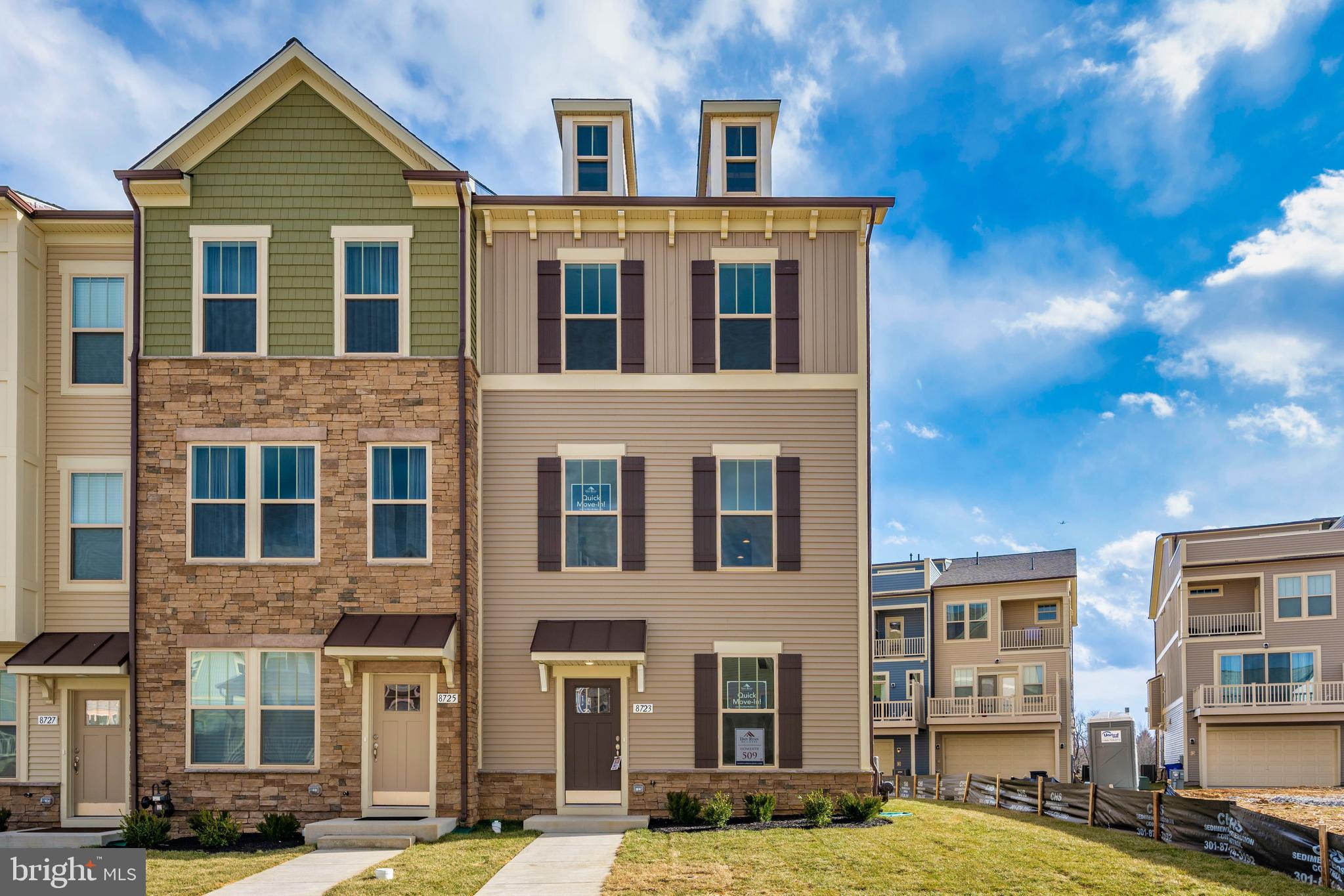 a front view of a residential apartment building with a yard