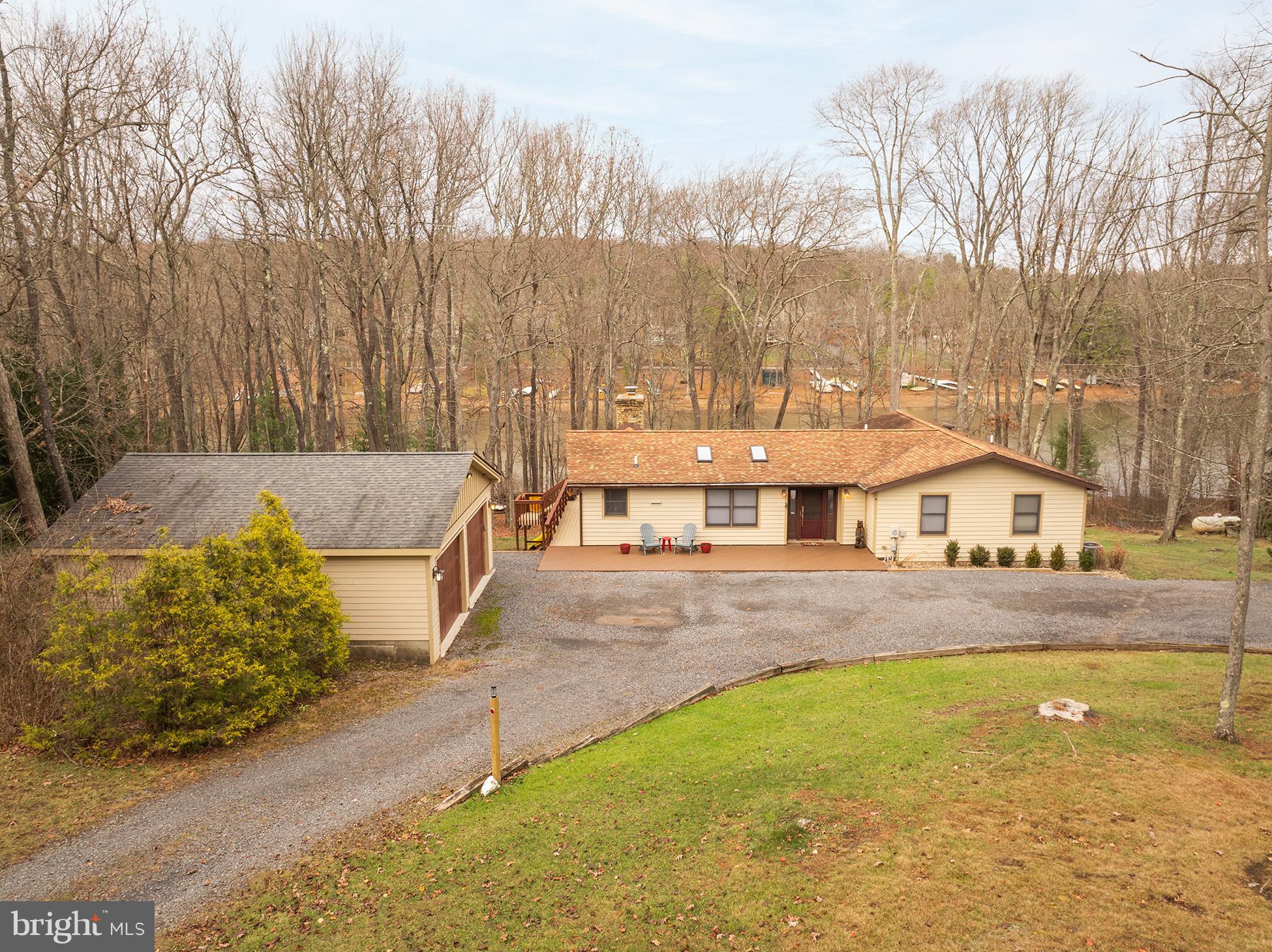 a view of a house with a yard and sitting area