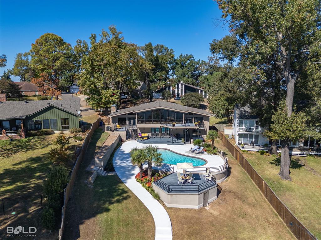 an aerial view of a house with swimming pool garden and patio