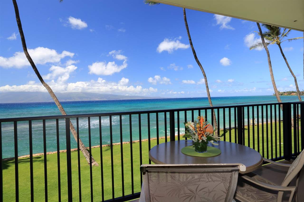 a balcony with table and chairs