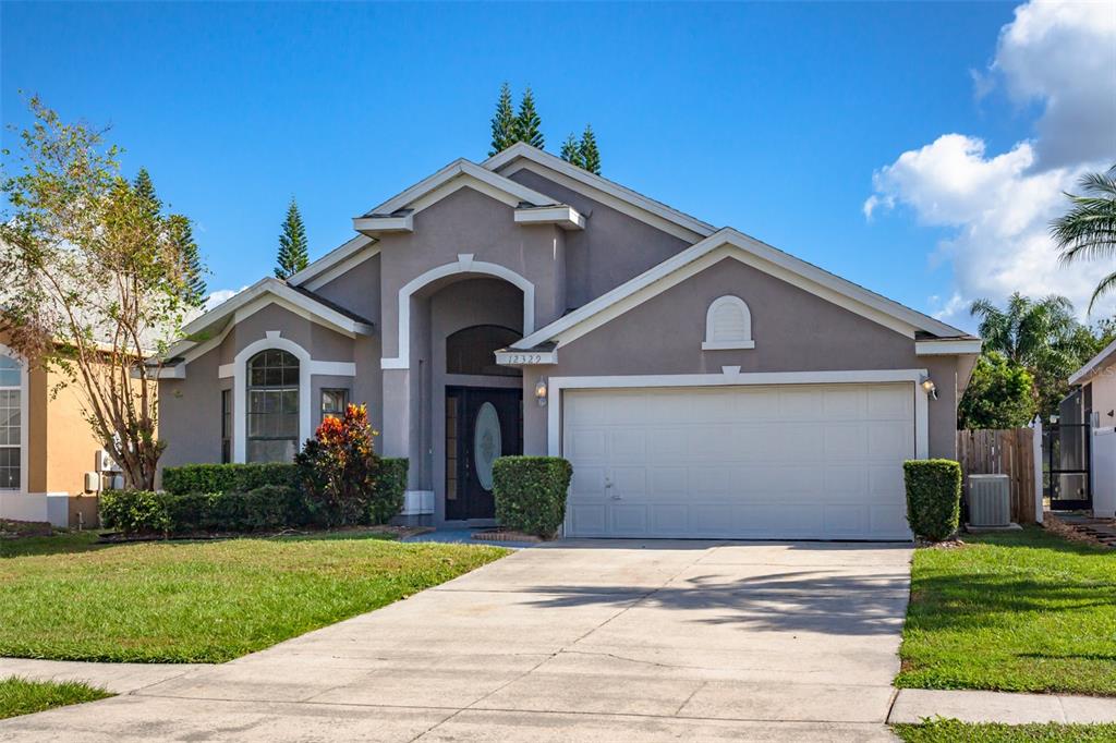 a front view of a house with a yard and garage