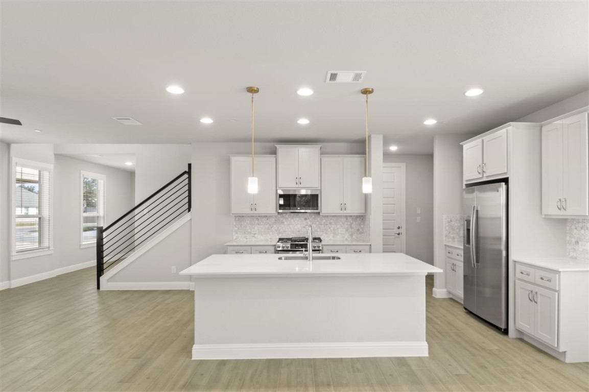 a view of kitchen with cabinets and stainless steel appliances