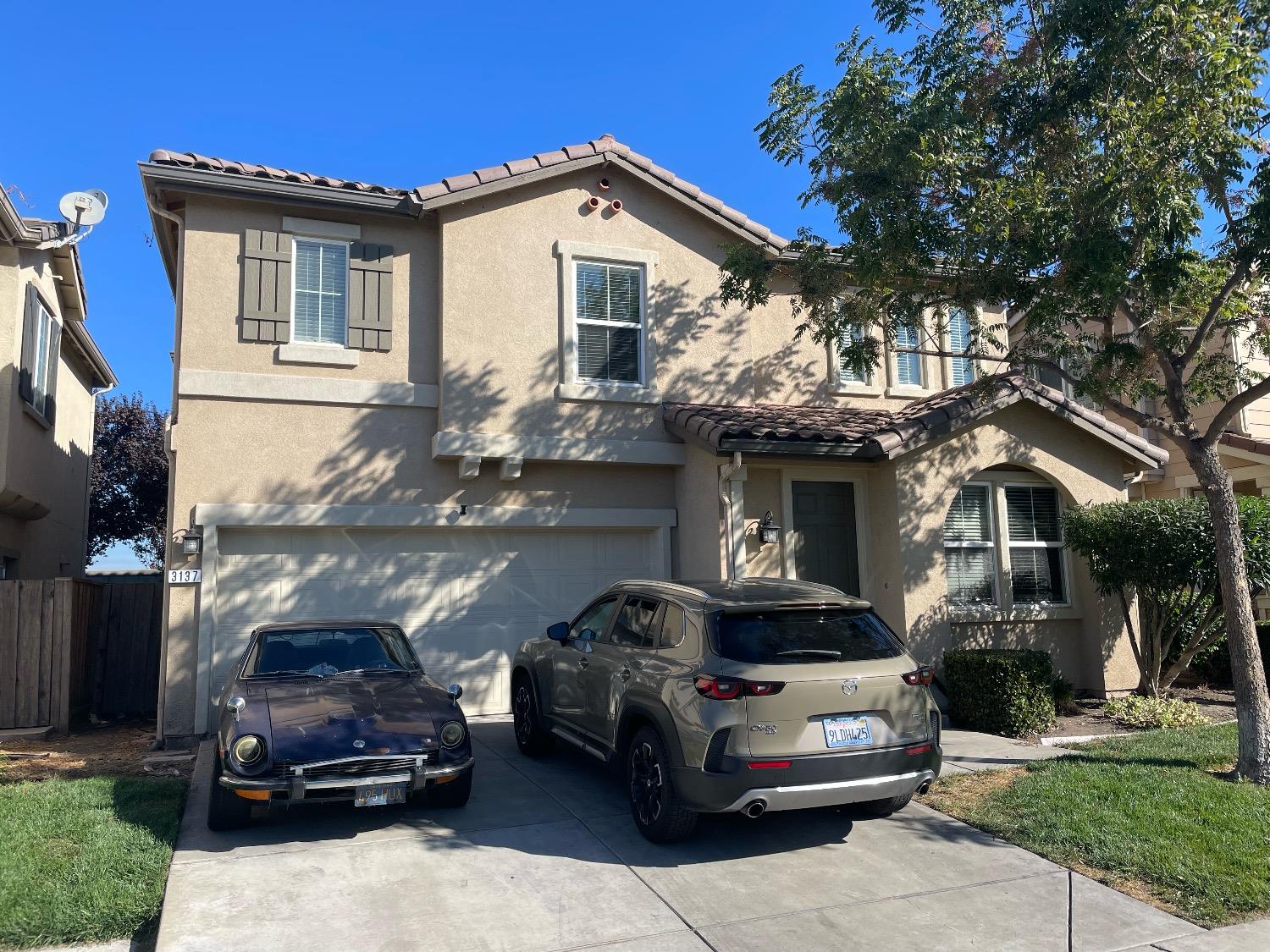 a front view of a house with parking space