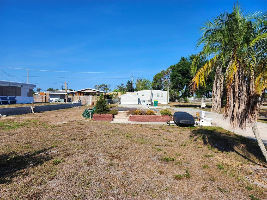 a view of yard with swimming pool and trees