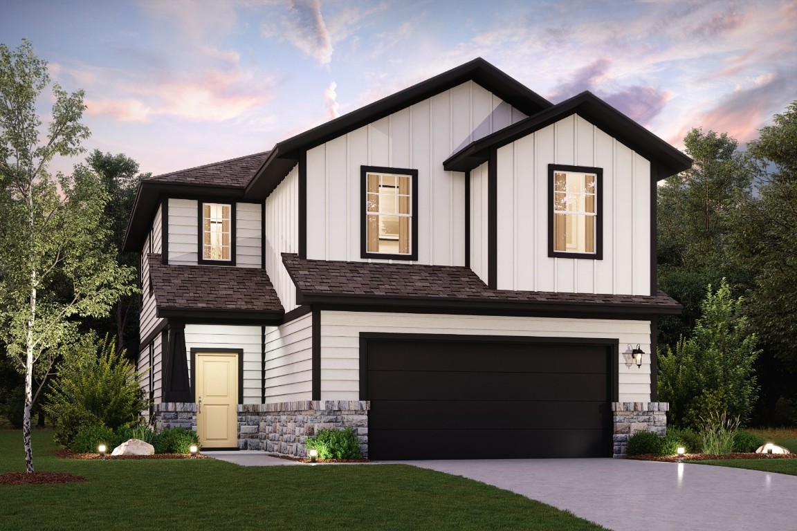 a front view of a house with a yard and garage