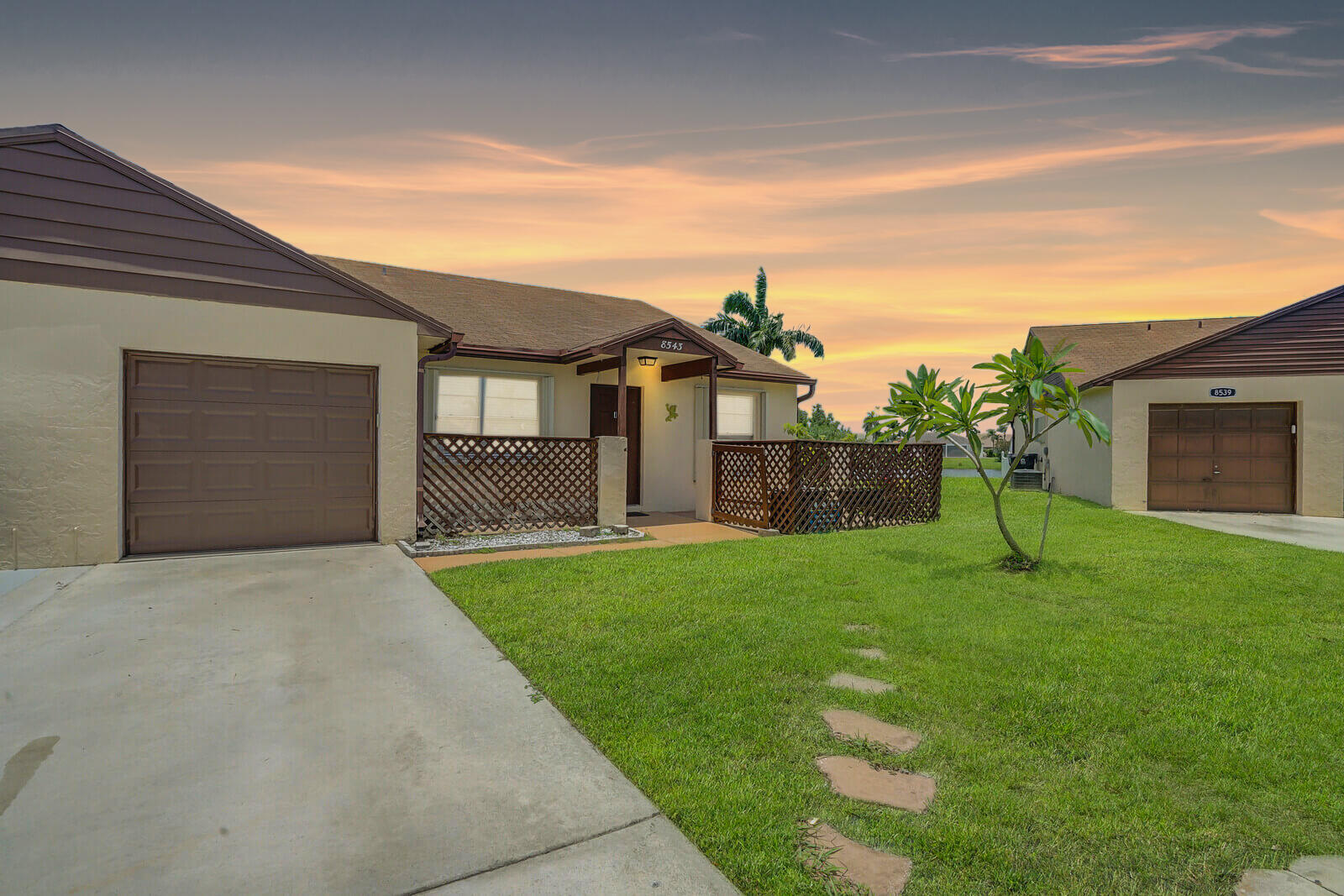 a view of a house with backyard and a garden