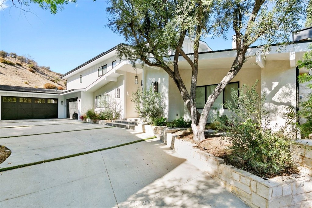 a view of a building with a yard and potted plants