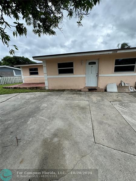 a front view of a house with parking space