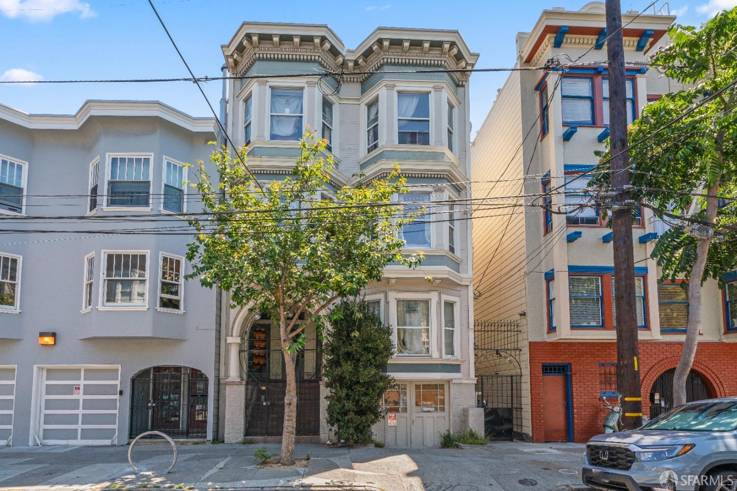 a front view of a residential apartment building with a yard