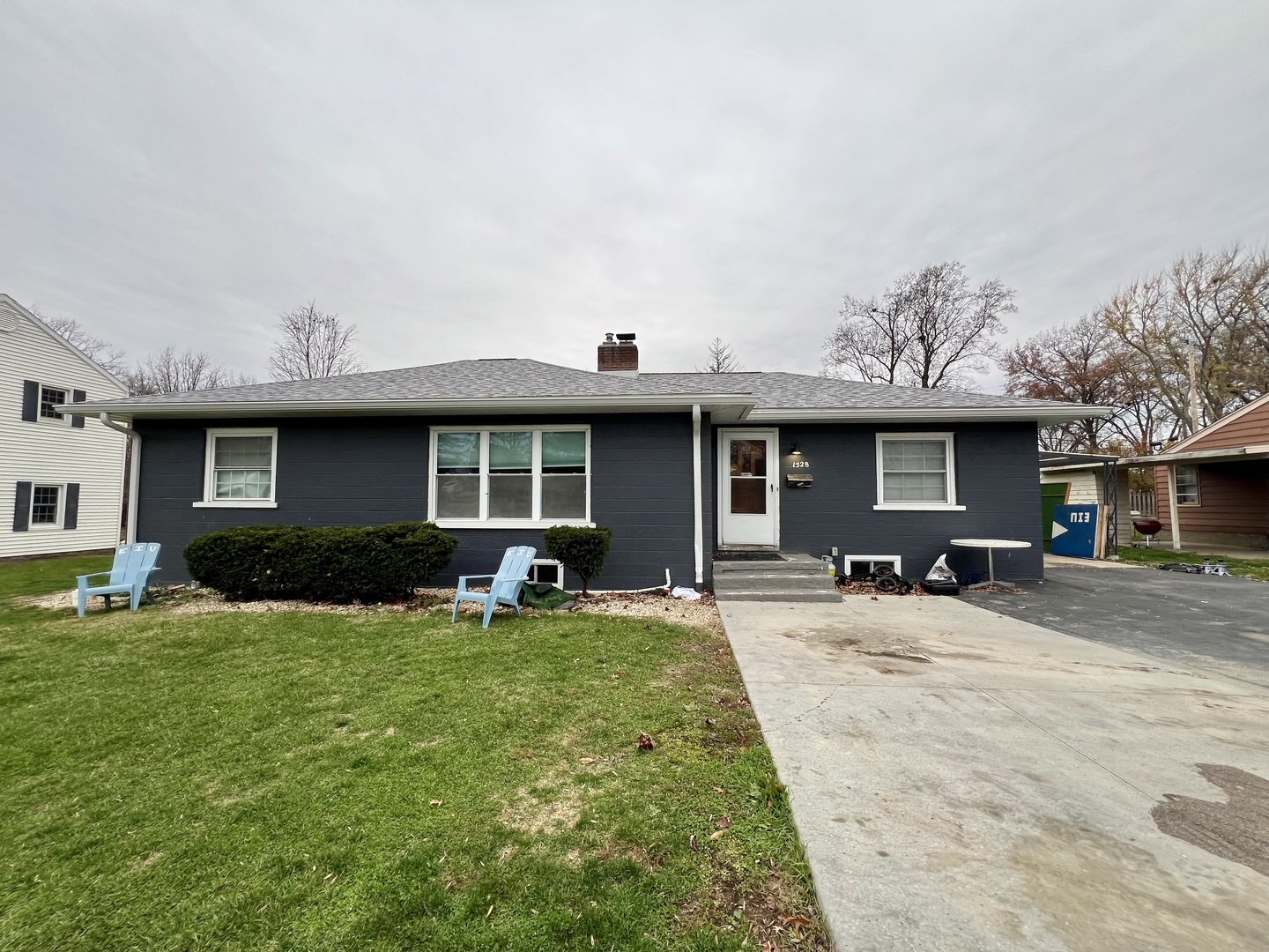 a front view of a house with yard and green space