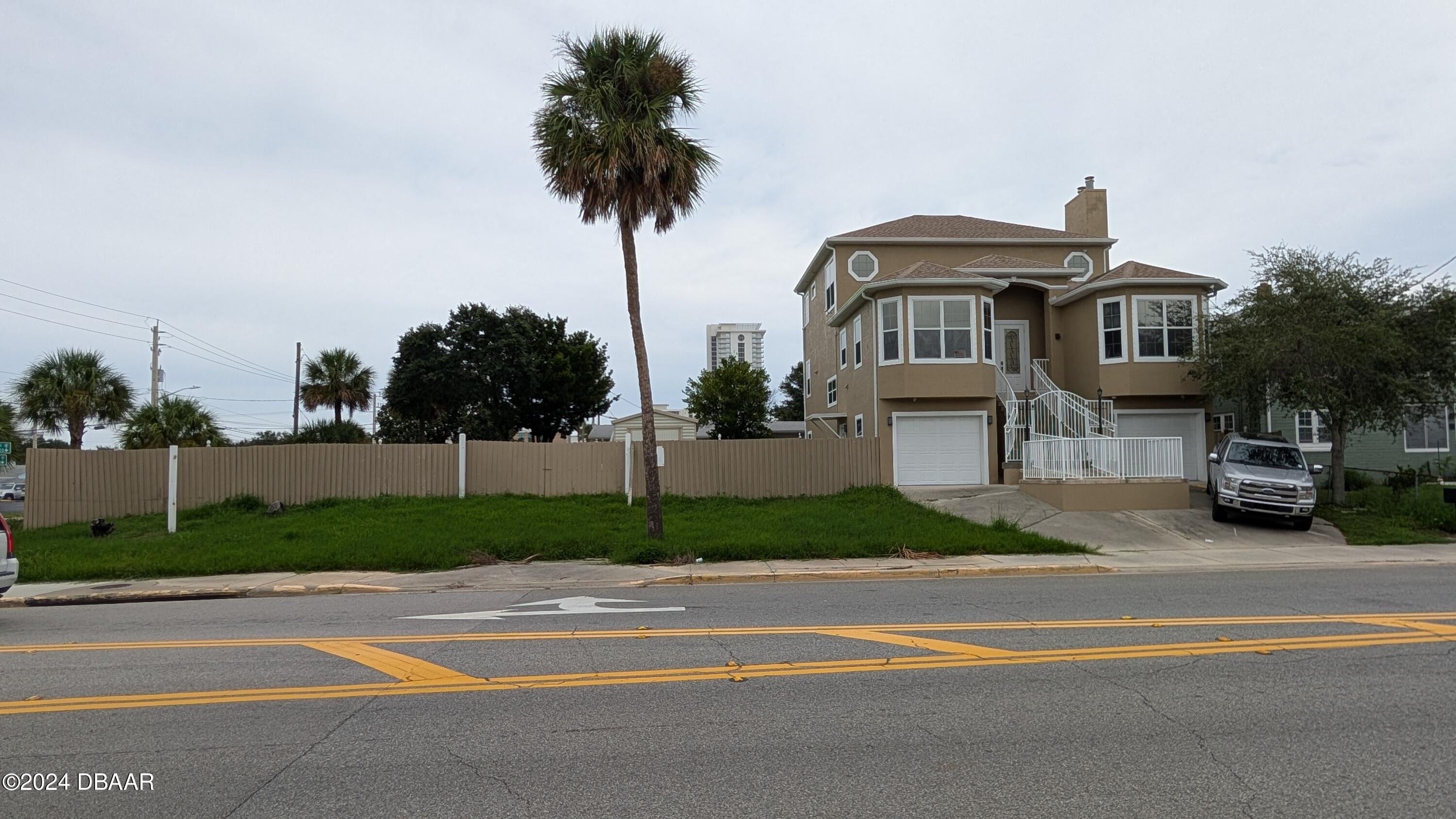 a front view of a house with a garden and plants